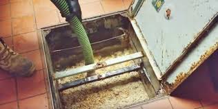 Commercial grease trap being pumped and cleaned at a restaurant in Conroe Texas