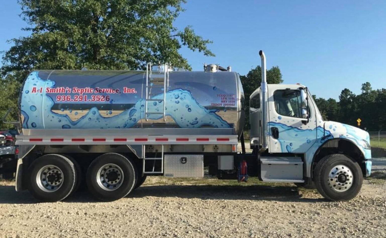 A-1 Smith's Septic Service pump truck with blue water wave design servicing residential septic systems in Huntsville Texas